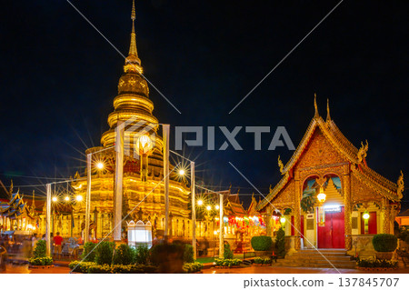 Wat Phra That Hariphunchai, a temple in Lamphun Province, Thailand, is beautifully decorated with lights at night. It is an ancient temple from the original Lanna era. 137845707