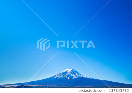 Mt. Fuji on a clear day with blue sky It is a symbol of Yamanashi City, Lake Kawaguchiko, Japan. Copy space background Mt. Fuji on a clear day with blue sky It is a symbol of Yamanashi City, Lake Kawaguchiko, Japan. Copy space background 137845713