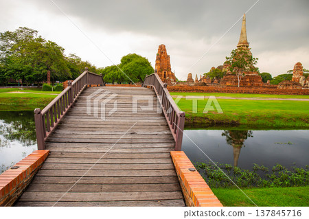 River bridge at Wat Mahathat temple Ayutthaya with Historical Park background, Thailand River bridge at Wat Mahathat temple Ayutthaya with Historical Park background, Thailand 137845716