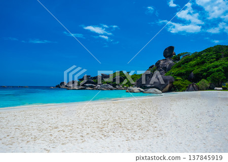 Beautiful view with blue sky and clouds, blue sea and white sand beach on Similan island, No.8 at Similan national park, Phuket, Thailand is most popular vacation for tourist. Beautiful view with blue sky and clouds, blue sea and white sand beach on Similan island, No.8 at Similan national park, Phuket, Thailand is most popular vacation for tourist. 137845919