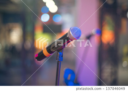 Professional Wireless Vocal Microphone on Stage with Neon Bokeh and Copy Space Professional Wireless Vocal Microphone on Stage with Neon Bokeh and Copy Space 137846049