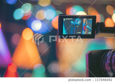 Professional Video Camera Recording Live Show with Colorful Bokeh and Copy Space Professional Video Camera Recording Live Show with Colorful Bokeh and Copy Space 137846092