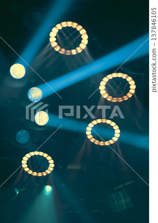 Abstract Stage Lighting Pattern with Teal Beams and Warm Yellow Rings with copy space 137846105