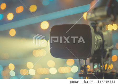 Professional Television Camera with Bokeh Lights Background and copy space Professional Television Camera with Bokeh Lights Background and copy space 137846113