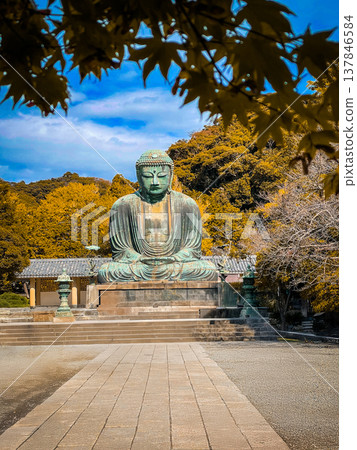 Daibutsu or Great Buddha of Kamakura in Kotokuin Temple at Kanagawa Prefecture Japan with leaves changing color It is an important landmark and a popular destination for tourists and pilgrims. Daibutsu or Great Buddha of Kamakura in Kotokuin Temple at Kanagawa Prefecture Japan with leaves changing color It is an important landmark and a popular destination for tourists and pilgrims. 137846584