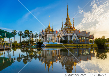 Wat Non Kum or Wat Luang Pho To in Sikhio District, Nakhon Ratchasima, Korat, Thailand is a symbolic place of temples in Thailand. At sunset, there is a reflection in the water. Wat Non Kum or Wat Luang Pho To in Sikhio District, Nakhon Ratchasima, Korat, Thailand is a symbolic place of temples in Thailand. At sunset, there is a reflection in the water. 137846724