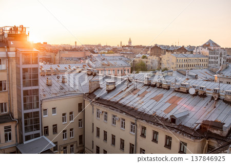 Golden sunlight illuminates the rooftops of St Petersburg as day transitions to night, highlighting the citys historical buildings and tranquil atmosphere. Golden sunlight illuminates the rooftops of St Petersburg as day transitions to night, highlighting the citys historical buildings and tranquil atmosphere. 137846925
