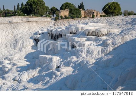 Pamukkale showcases remarkable white travertine terraces formed by mineral-laden thermal waters, creating a breathtaking landscape perfect for exploration. Pamukkale showcases remarkable white travertine terraces formed by mineral-laden thermal waters, creating a breathtaking landscape perfect for exploration. 137847018