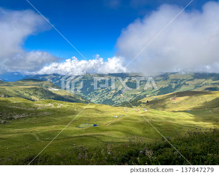 Mountain pastures and clouds above alpine valleys in Les Contamines-Montjoie, France 137847279