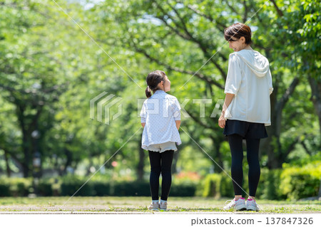A parent and child walking A parent and child walking 137847326