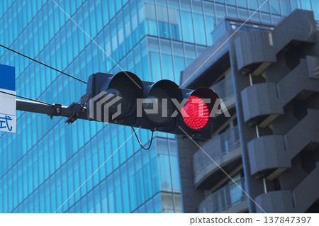 A lit red light. An image of a traffic signal symbolizing stop, prohibition, passing, and risk avoidance. 137847397