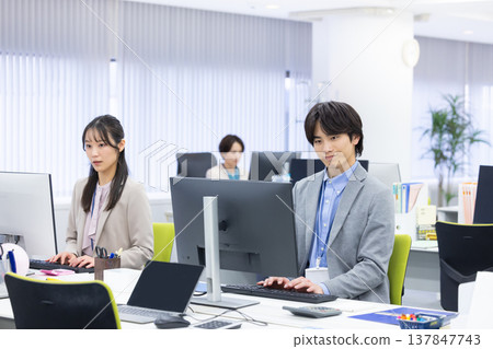 Men and women working in business offices Men and women working in business offices 137847743