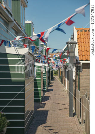 Festive Narrow Street in Marken Village with Dutch Flags and Copy Space Festive Narrow Street in Marken Village with Dutch Flags and Copy Space 137847953