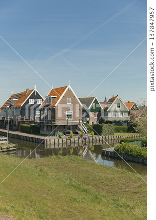 Traditional Wooden Houses on Stilts in Marken Netherlands with Copy Space Traditional Wooden Houses on Stilts in Marken Netherlands with Copy Space 137847957