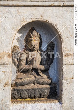 Ancient Hindu Deity Statue in Stone Niche Nepal with Copy Space 137847985