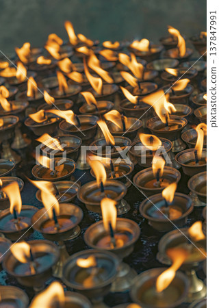 Traditional Buddhist Oil Butter Lamps Burning in Nepal Temple with Copy Space 137847991