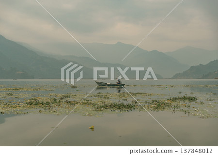 Lonely Boat on Phewa Lake in Pokhara Nepal with Misty Mountains and Copy Space Lonely Boat on Phewa Lake in Pokhara Nepal with Misty Mountains and Copy Space 137848012
