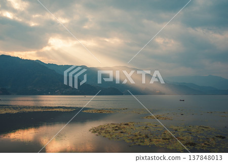 Sun Rays Over Phewa Lake and Mountains in Pokhara Nepal with Copy Space 137848013