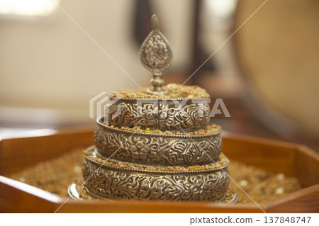 Tibetan Buddhist Mandala Offering Set with Grain on Ritual Altar with Copy Space Tibetan Buddhist Mandala Offering Set with Grain on Ritual Altar with Copy Space 137848747