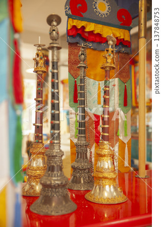 Traditional Tibetan Ritual Oboes Gyaling with Ornate Silver and Gold Engraving on Altar with Copy Space Traditional Tibetan Ritual Oboes Gyaling with Ornate Silver and Gold Engraving on Altar with Copy Space 137848753