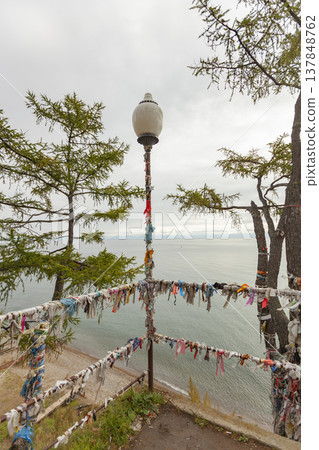 Sacred Ritual Ribbons Hadak on Lake Baikal Shore in Listvyanka with Copy Space for Travel Concept 137848762