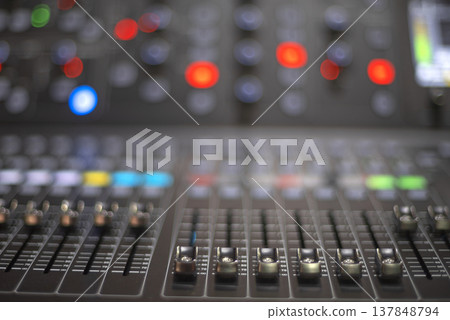 Professional Audio Mixing Console with Deep Bokeh and Copy Space for Text Professional Audio Mixing Console with Deep Bokeh and Copy Space for Text 137848794