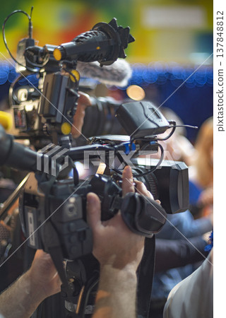 Professional Video Camera Operator Filming Live Event with Copy Space for Media Concept 137848812