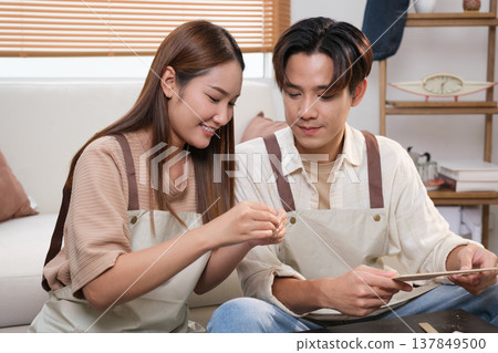 A young Asian couple spend time together at home A young Asian couple spend time together at home 137849500