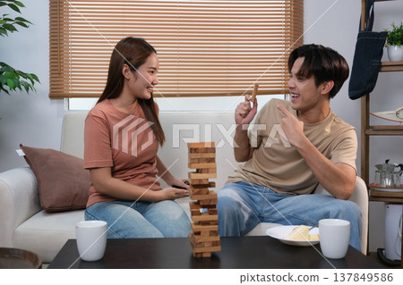 A young Asian couple spend time together at home A young Asian couple spend time together at home 137849586