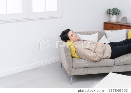 A man sleeping on the sofa A man sleeping on the sofa 137849902