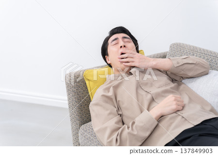 A man sleeping on the sofa A man sleeping on the sofa 137849903