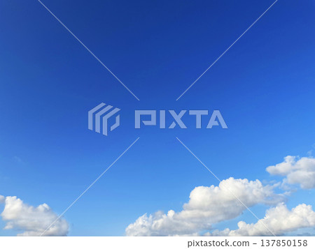 A horizontal background image of clouds floating in a blue sky. A horizontal background image of clouds floating in a blue sky. 137850158
