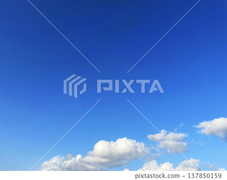 A horizontal background image of clouds floating in a blue sky. A horizontal background image of clouds floating in a blue sky. 137850159