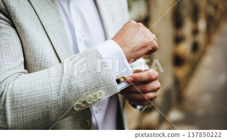 Close Up Of Groom Hands Adjusting Gold Cufflinks On White Shirt 137850222
