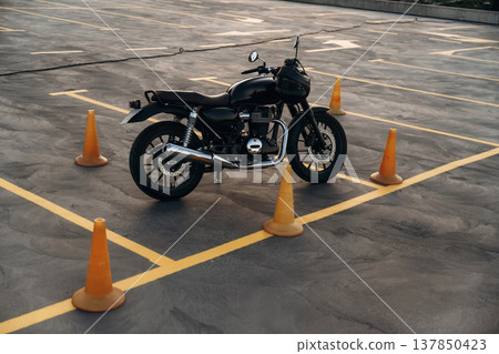 Black motorcycle is on the parking lot outdoors at daytime Black motorcycle is on the parking lot outdoors at daytime 137850423