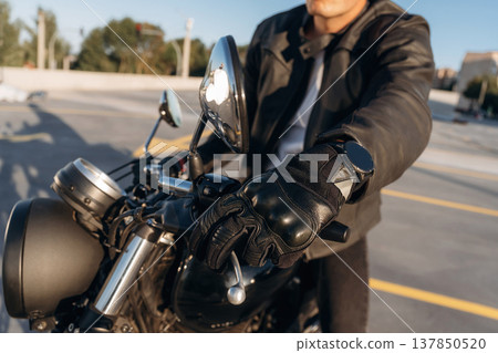 Parked, standing. Close up detailed view of man with motorcycle 137850520