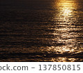 The sea glows golden in the evening. 137850815
