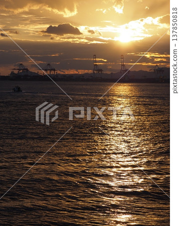 The sea glows golden in the evening. 137850818