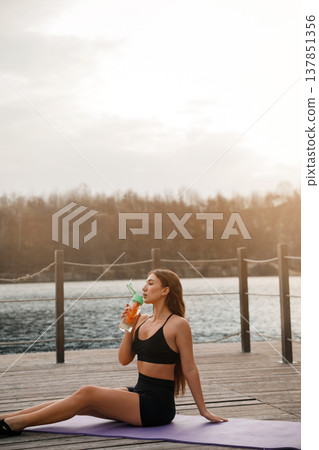 Young Woman Resting After Yoga Workout At Lake. Recovery And Relaxation Concept Young Woman Resting After Yoga Workout At Lake. Recovery And Relaxation Concept 137851356