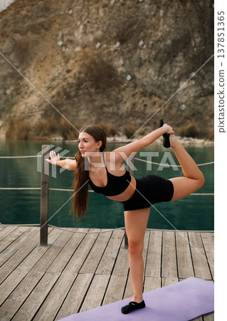 Beautiful Woman Performing Dancer Yoga Pose Outdoors At Lake. Flexibility And Balance Training Concept Beautiful Woman Performing Dancer Yoga Pose Outdoors At Lake. Flexibility And Balance Training Concept 137851365