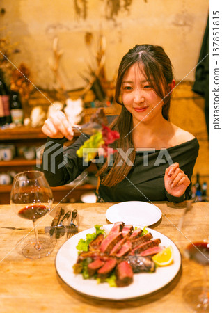 A woman enjoying red wine 137851815