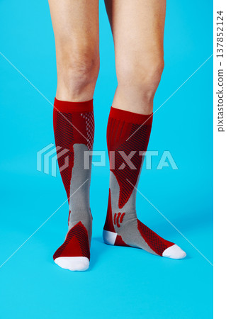 a man wearing red compression socks 137852124