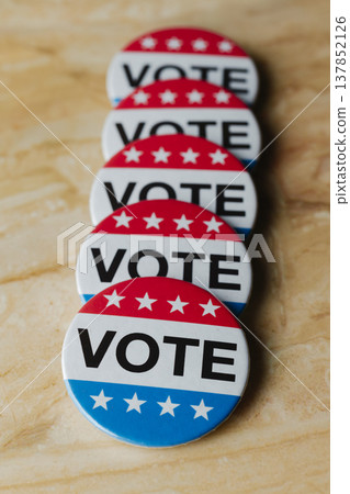 row of vote badges on a marble surface row of vote badges on a marble surface 137852126