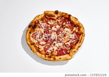 Pepperoni pizza top view placed on white plate on clean white background. Pepperoni pizza top view placed on white plate on clean white background. 137852229