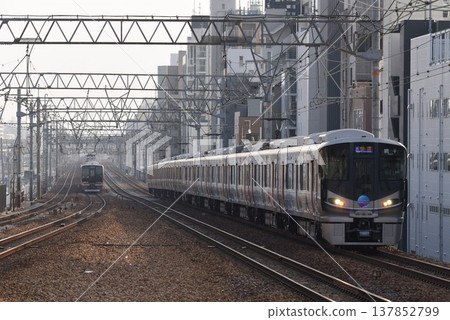 A southbound train passing through Sakura-Shukugawa Station on the quadruple-track Tokaido Main Line. A southbound train passing through Sakura-Shukugawa Station on the quadruple-track Tokaido Main Line. 137852799