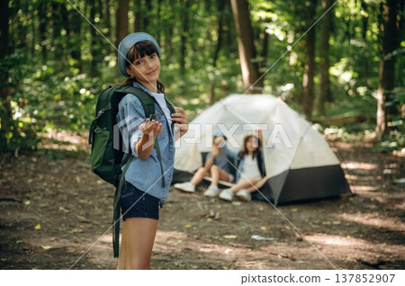 Camping with tent. Girls kids are in the forest, hiking 137852907