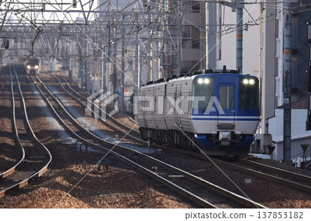 The Super Hakuto express train passes Sakura-Shukugawa Station on the quadruple-track Tokaido Main Line 137853182