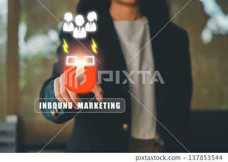Professional woman illustrating inbound marketing strategy with magnet and digital icons, symbolizing customer attraction. Professional woman illustrating inbound marketing strategy with magnet and digital icons, symbolizing customer attraction. 137853544