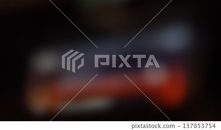 Blurred image of an object with indistinct colors and shapes, featuring a mix of dark and light areas, creating an abstract visual effect Blurred image of an object with indistinct colors and shapes, featuring a mix of dark and light areas, creating an abstract visual effect 137853754