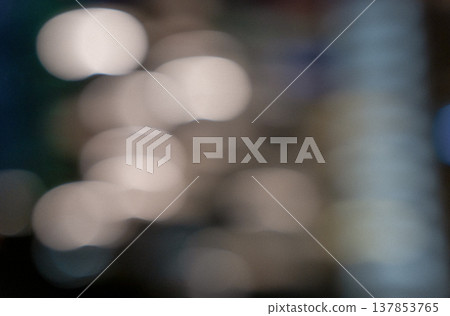 Blurred background with soft bokeh lights in various colors creating an abstract visual effect suitable for backgrounds or artistic designs 137853765